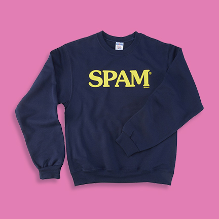 Crew neck sweater that says SPAM on a pink background.